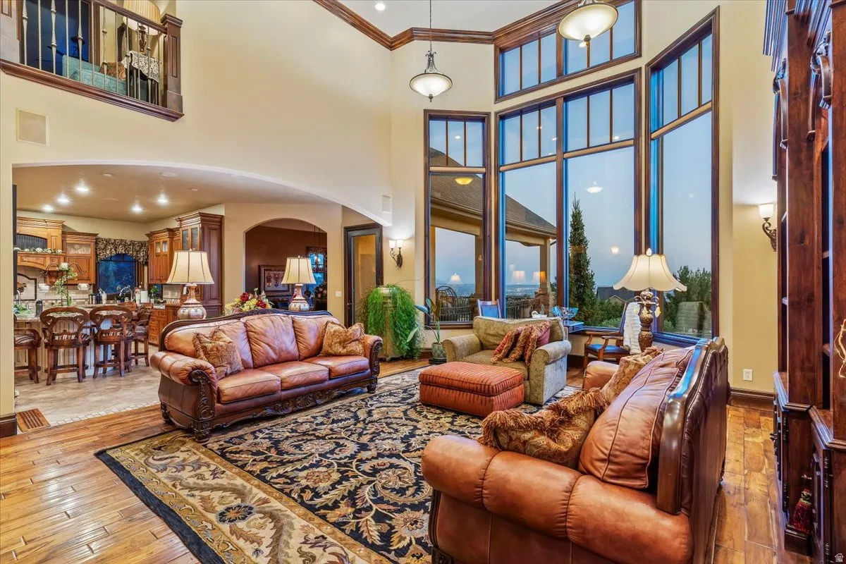 Great room featuring two-story ceilings, extensive wood trim details, and large picture windows