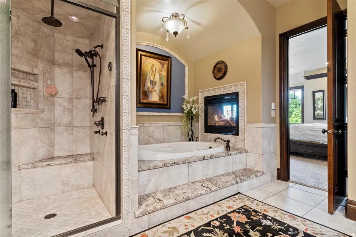 Full bathroom featuring a glass-enclosed shower with tiled walls and a built-in bench