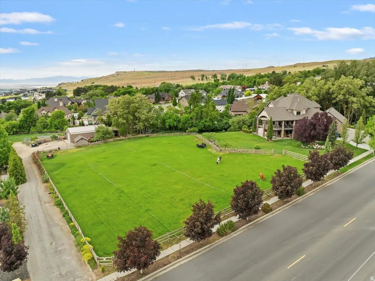 Two expansive horse patures, open green space, barn, tack room, and stables.
