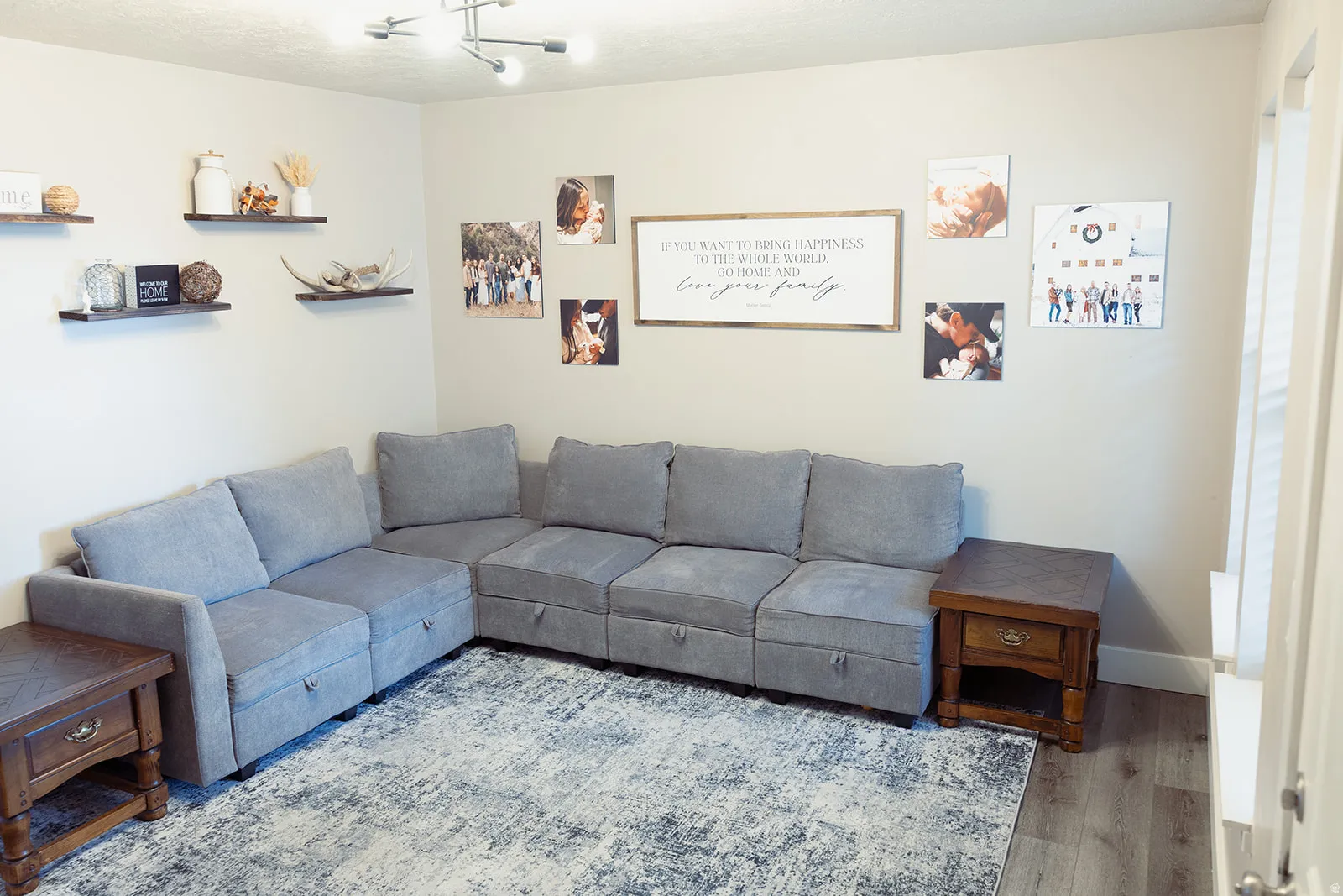 Spacious interior room featuring light-toned walls and wood-finish flooring