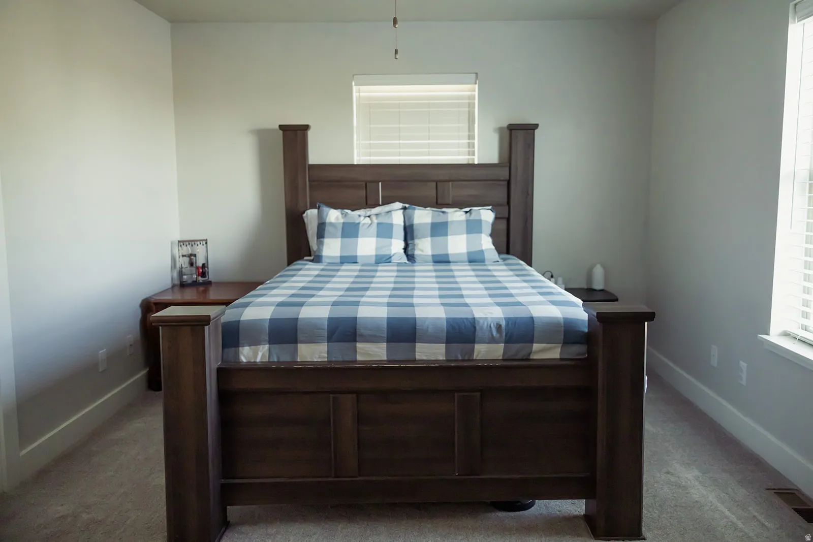 Carpeted bedroom with neutral wall paint and white trim