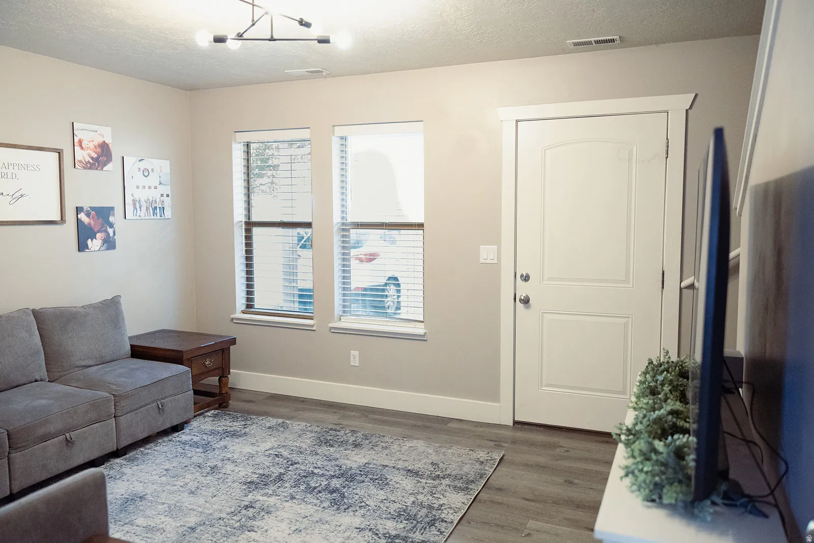 Light gray wood-finish flooring complements neutral wall tones