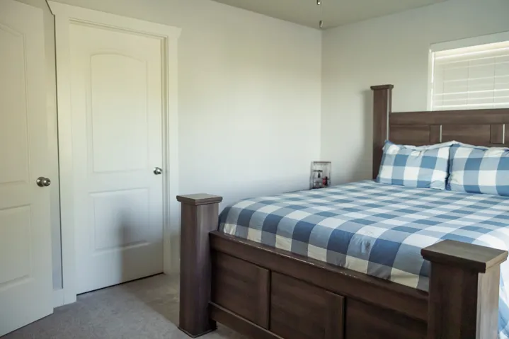 Light-colored walls enhance the brightness of this space, featuring two panel doors with chrome hardware