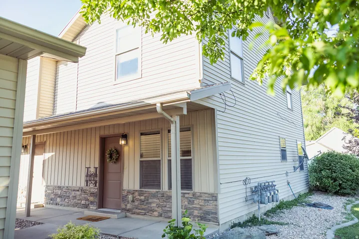 Two-story exterior with horizontal siding and a stone veneer accent
