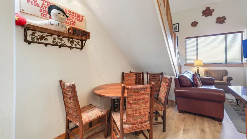 Open concept living area with wood-finish flooring