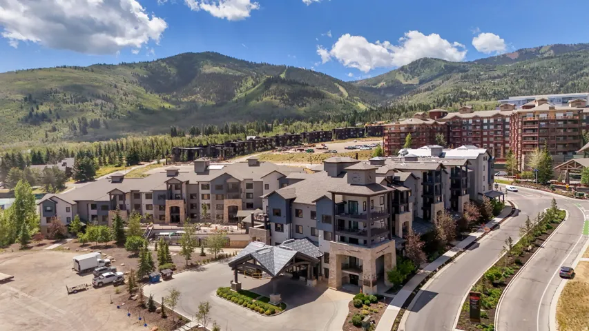 Contemporary multi-story building featuring stone and wood-finish accents