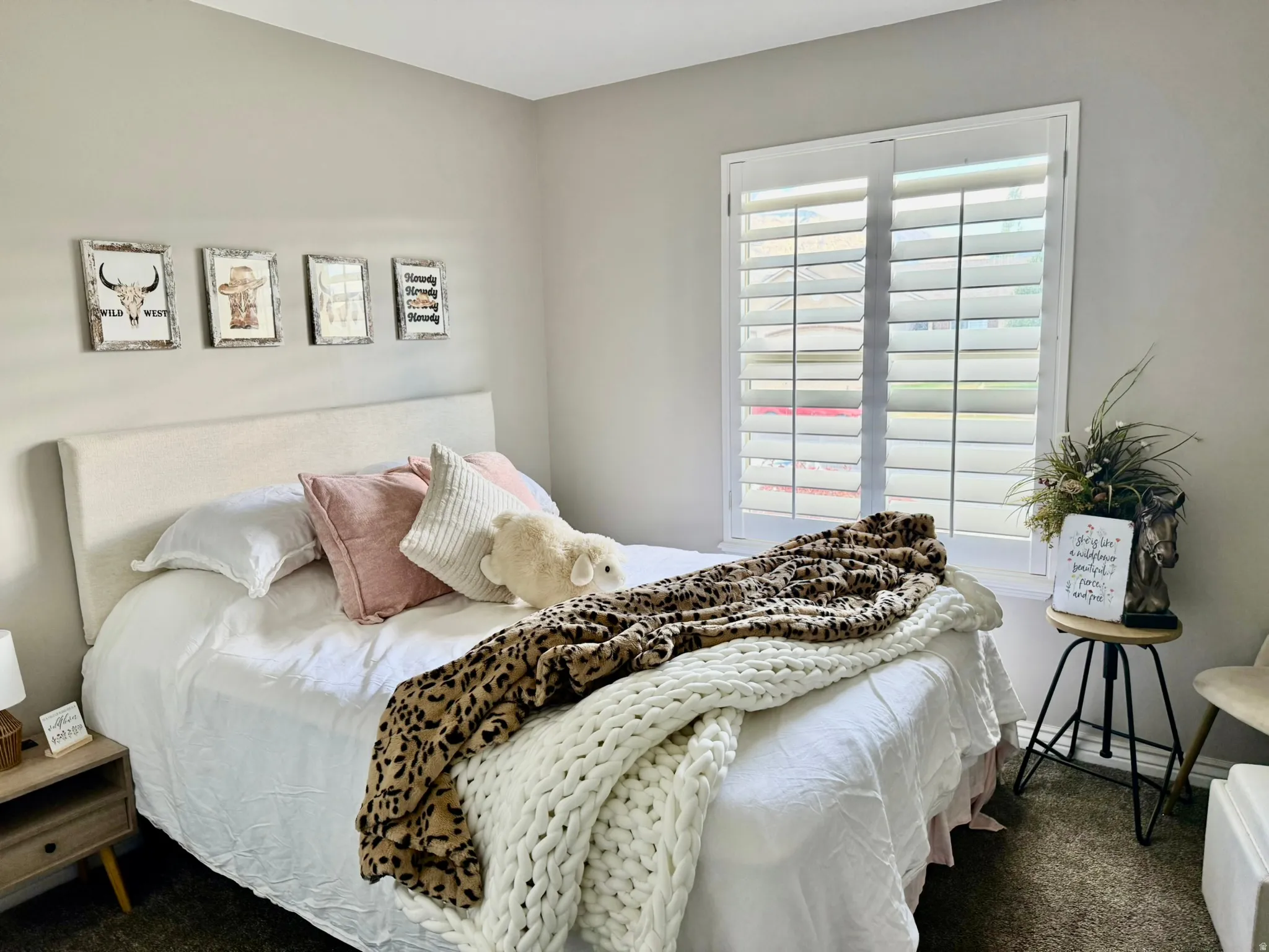 White plantation shutters frame a window, providing controlled natural light