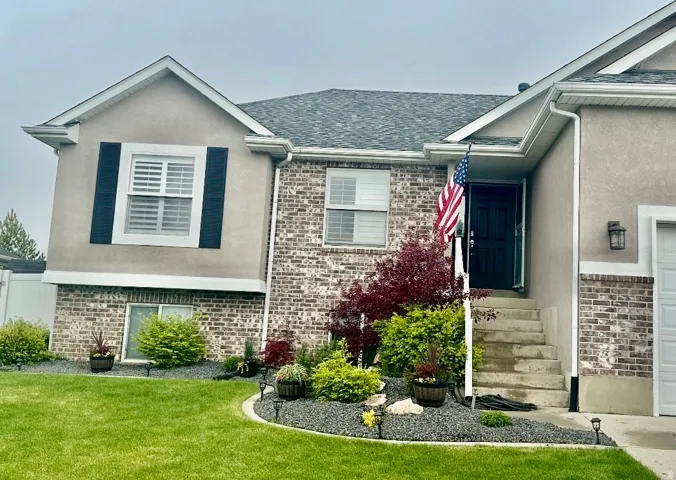 Exterior facade featuring brick accents and stucco siding