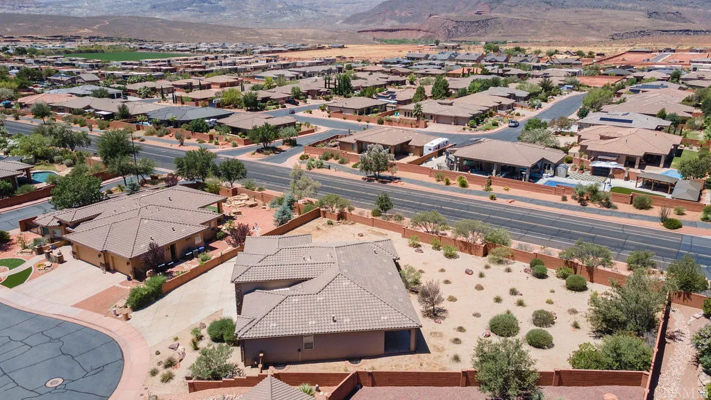 Neighborhood aerial showcasing residential properties with terracotta-style roofs and surrounding xeriscaping