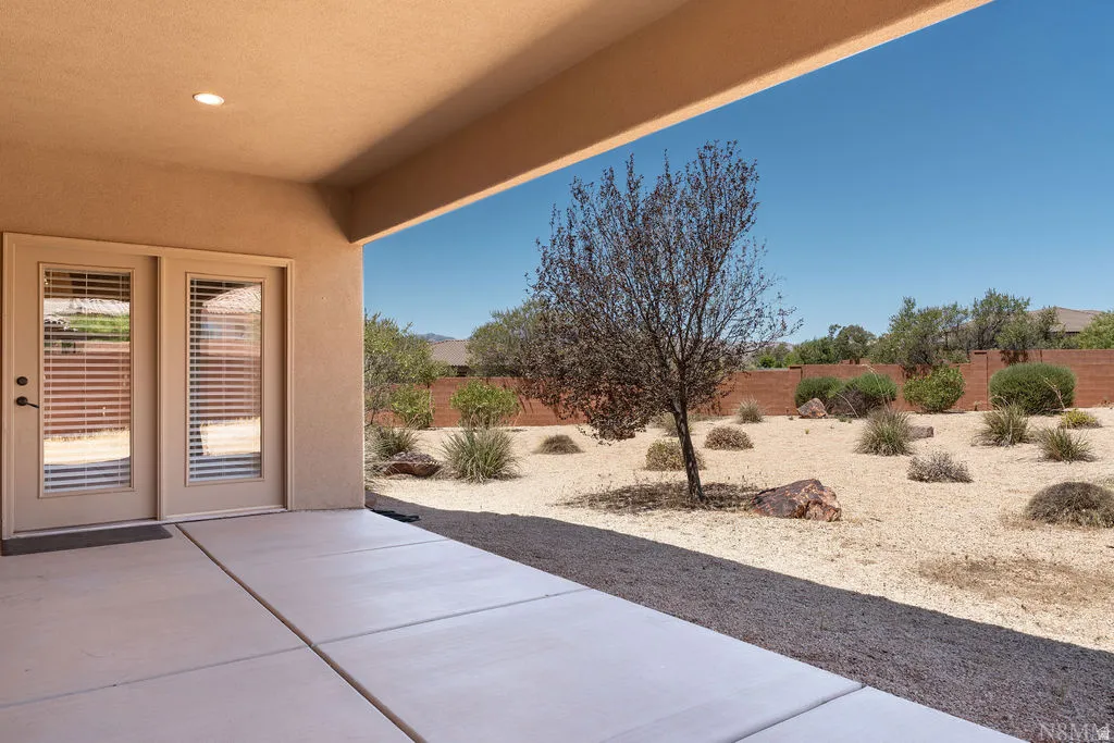 Covered patio featuring recessed lighting and dual French doors with integrated blinds