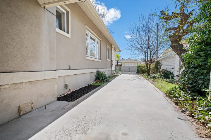 Long concrete driveway providing access to the rear of the property