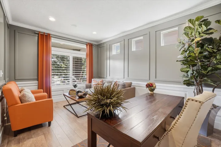 Living area featuring wood-finish flooring and extensive wainscoting