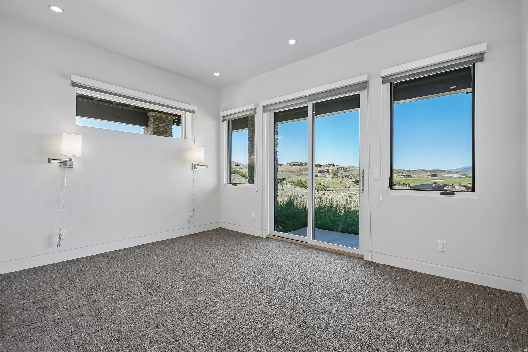 Contemporary interior with textured grey carpeting and white baseboards