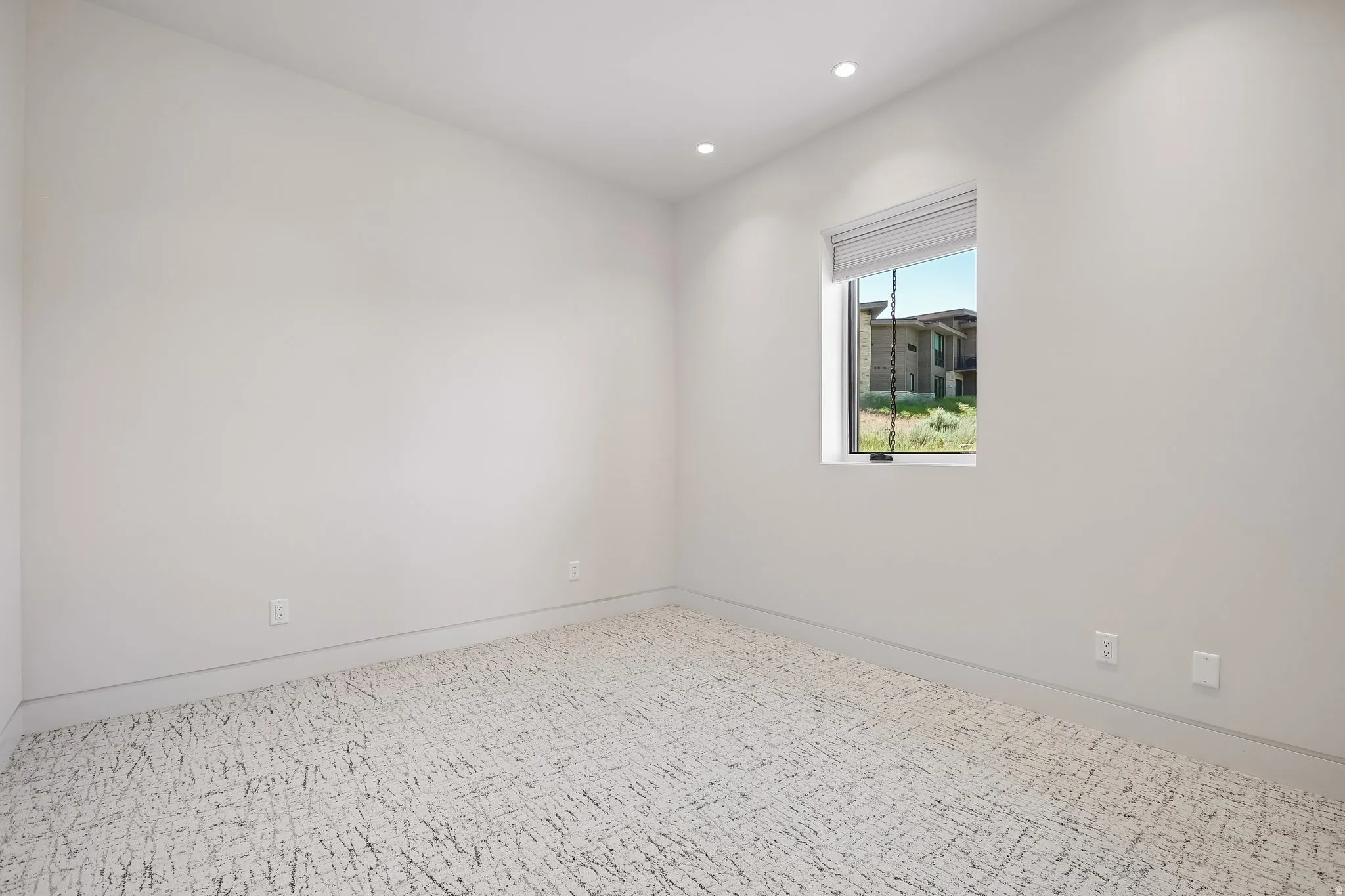 Room featuring a single window, recessed lighting, and patterned carpet flooring