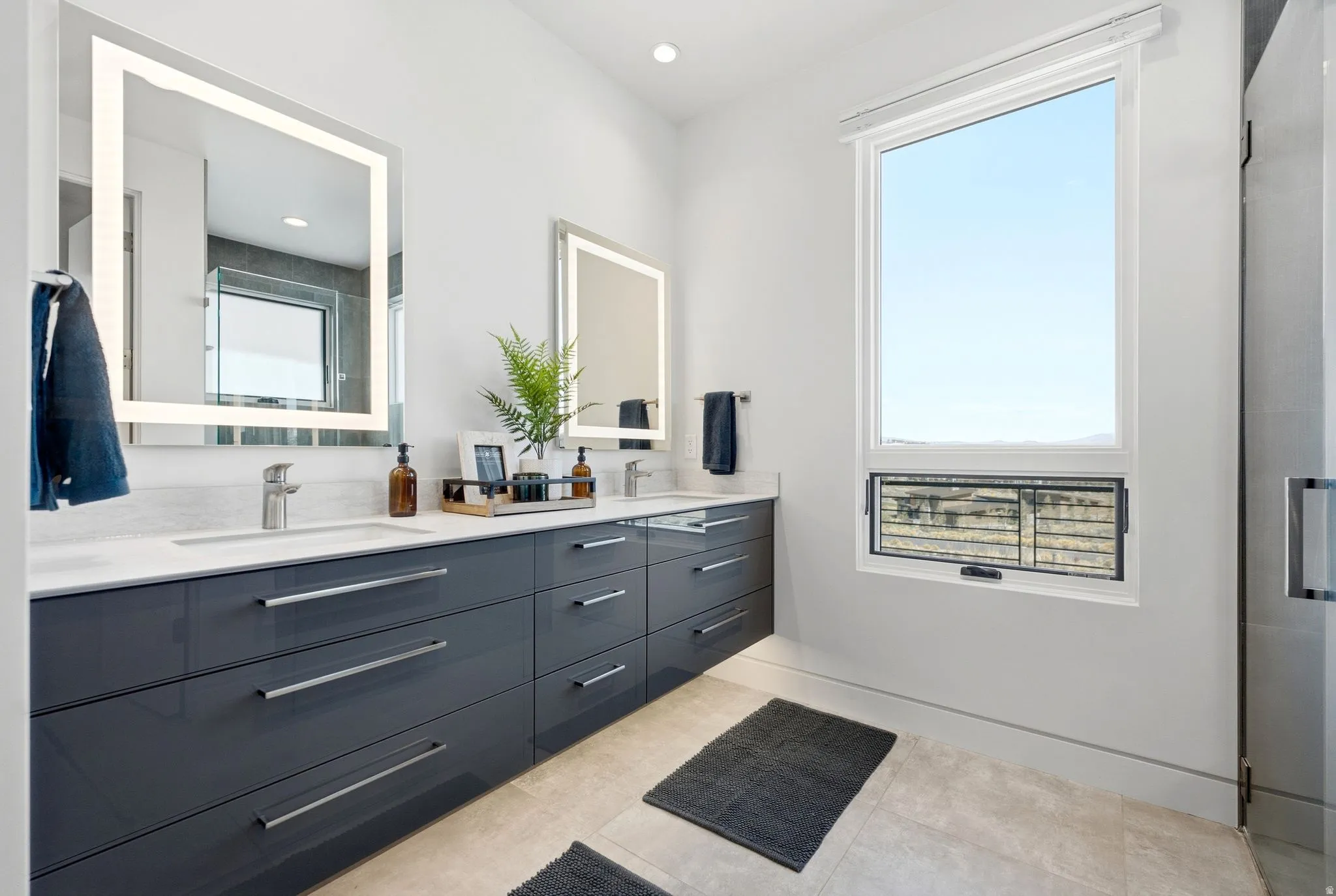 Dual vanity featuring a white countertop and dark gray cabinetry