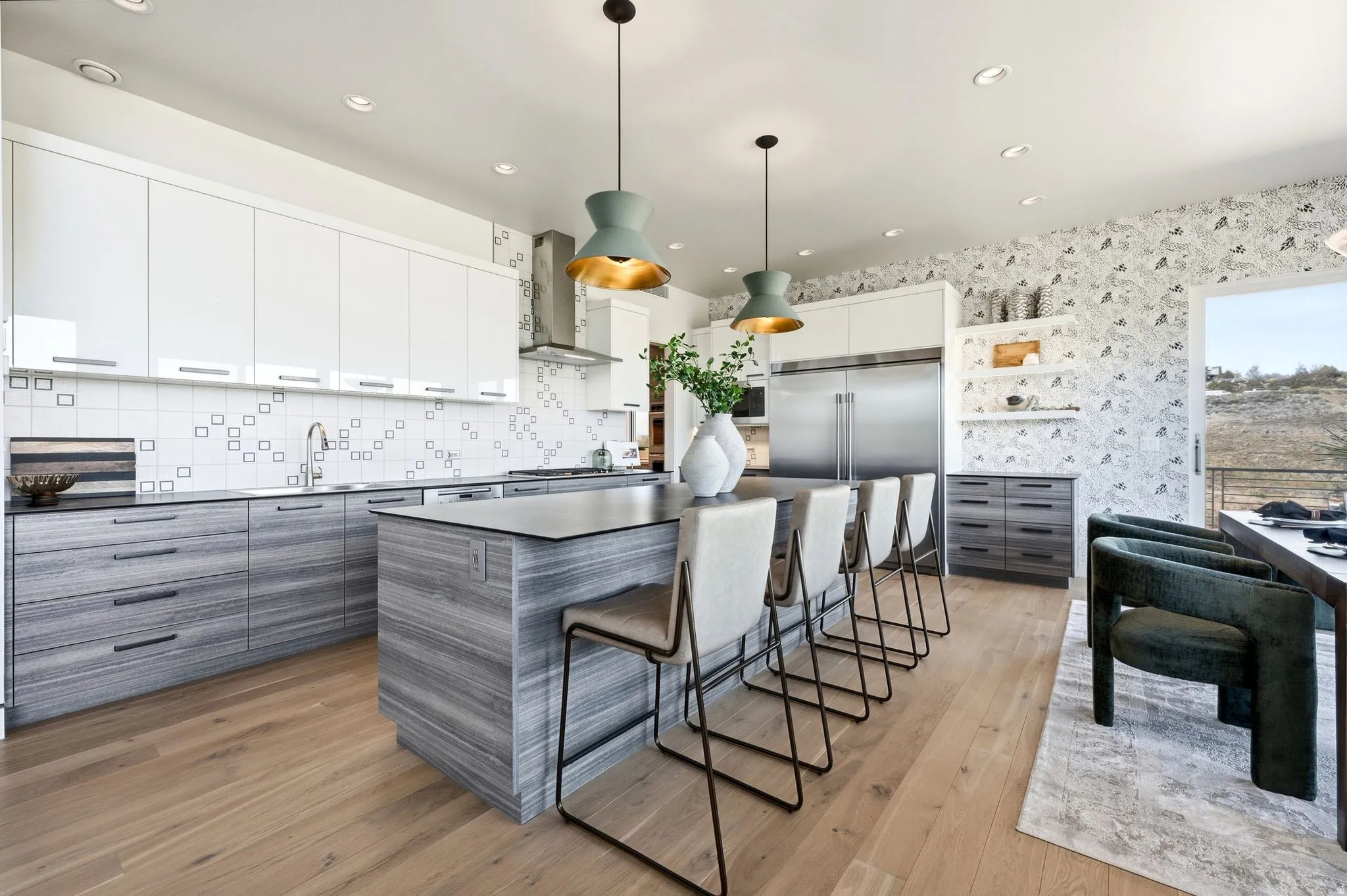 Gourmet kitchen with wood-finish flooring, two-tone cabinetry, stainless steel appliances, a large center island, and recessed lighting