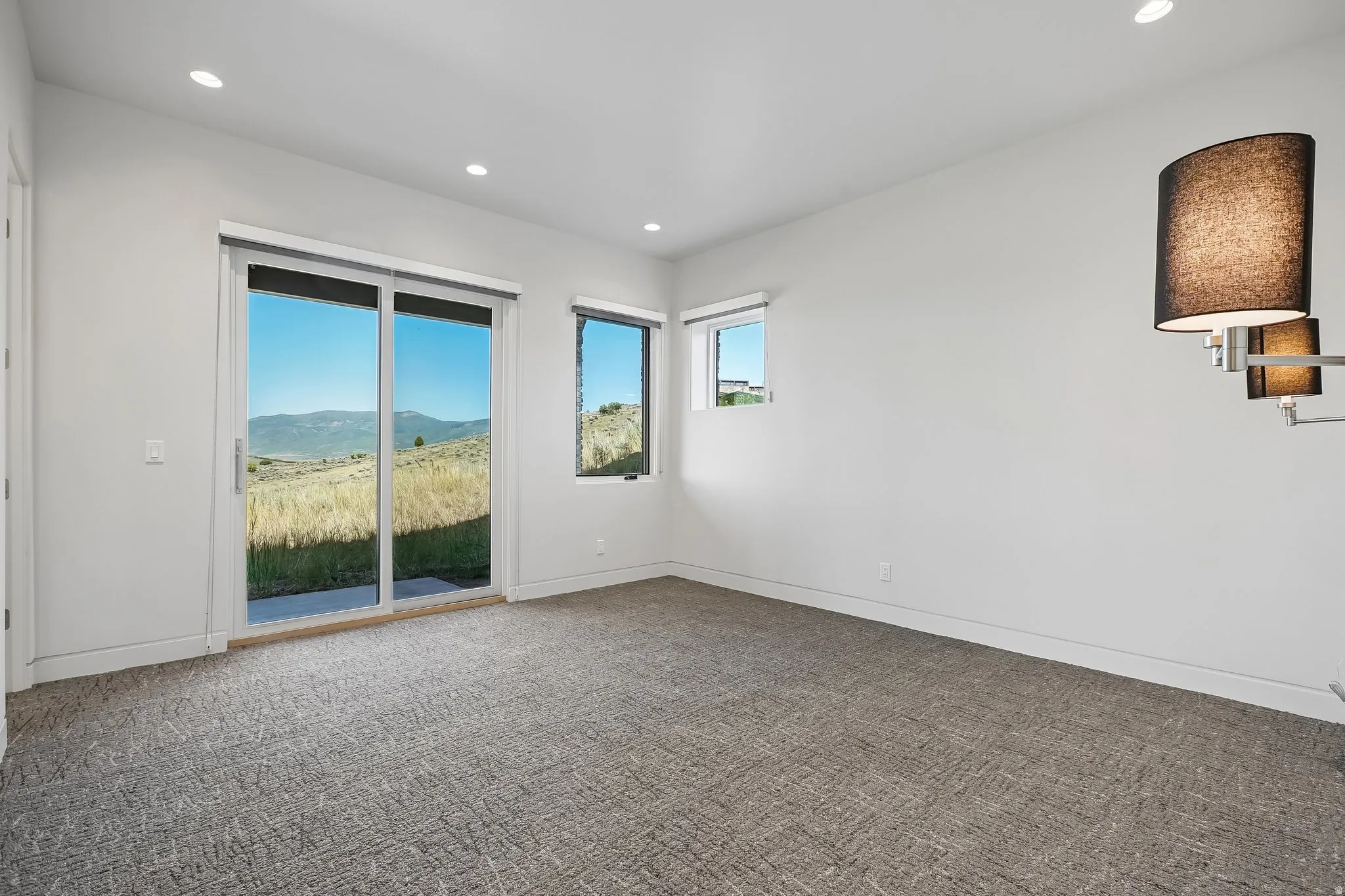 Sliding glass door leading to outdoor space, complemented by additional windows