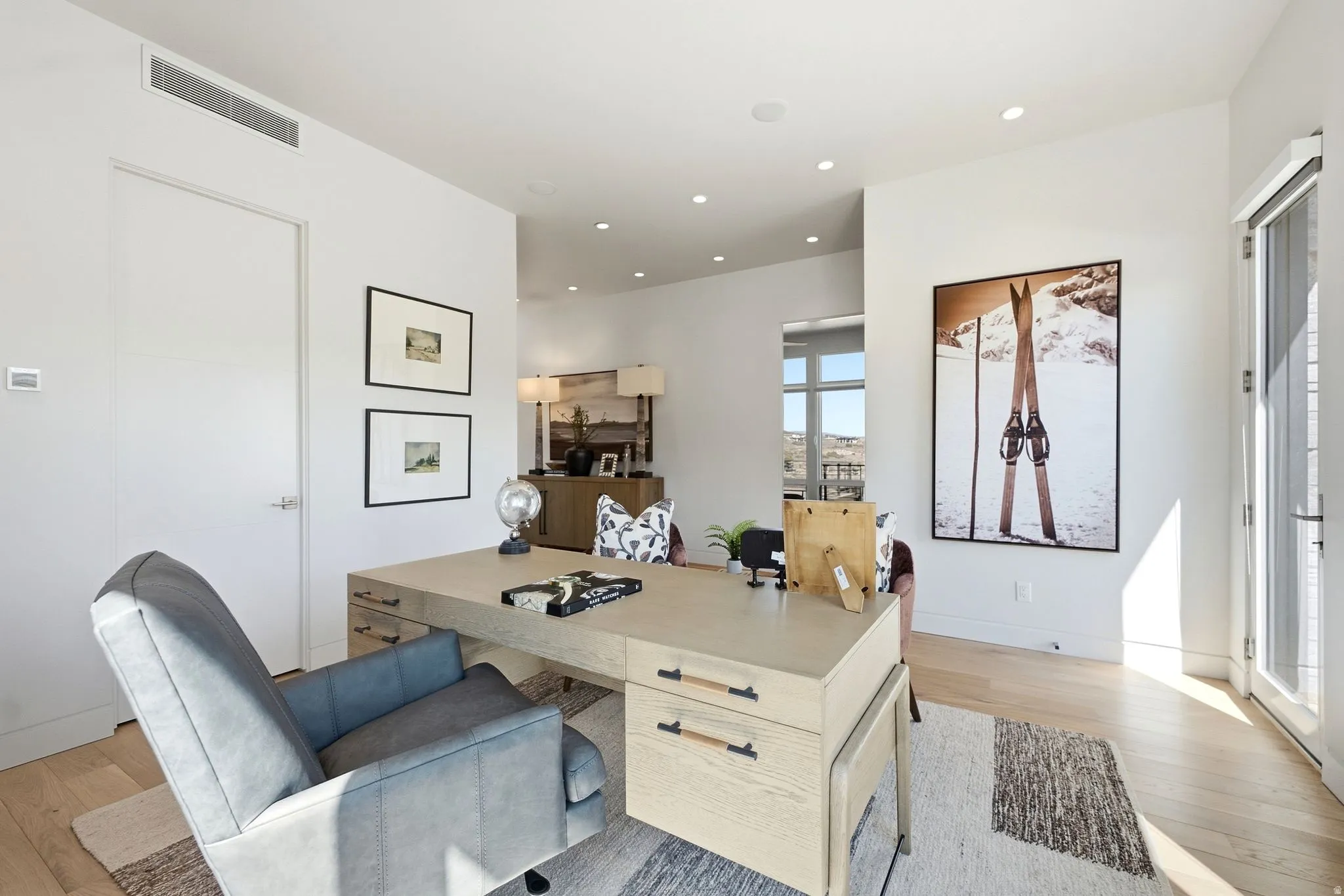 White walls with recessed lighting, wood-finish flooring, a full-light door, and a built-in linear vent