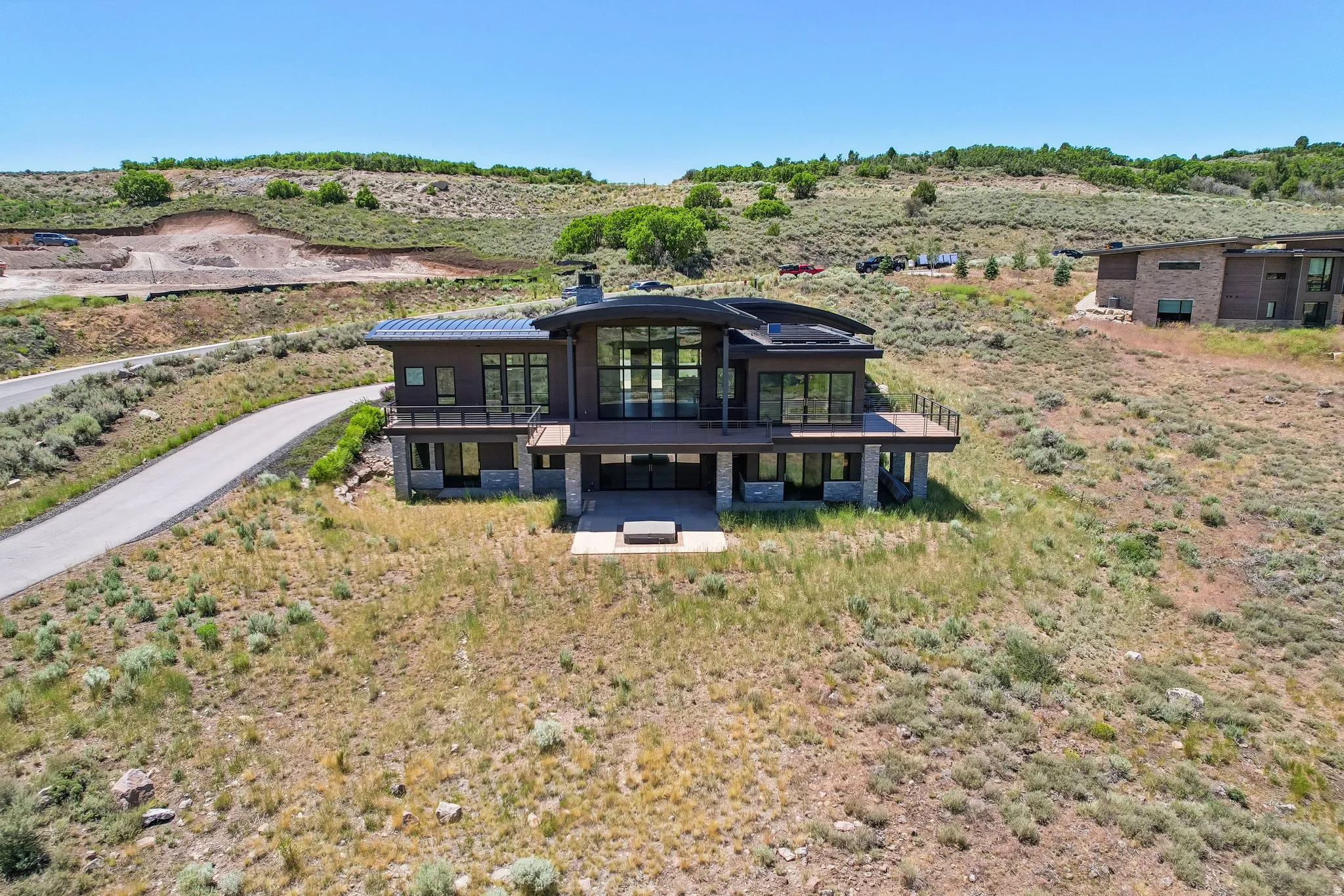 Contemporary architecture featuring dark siding and natural stone accents