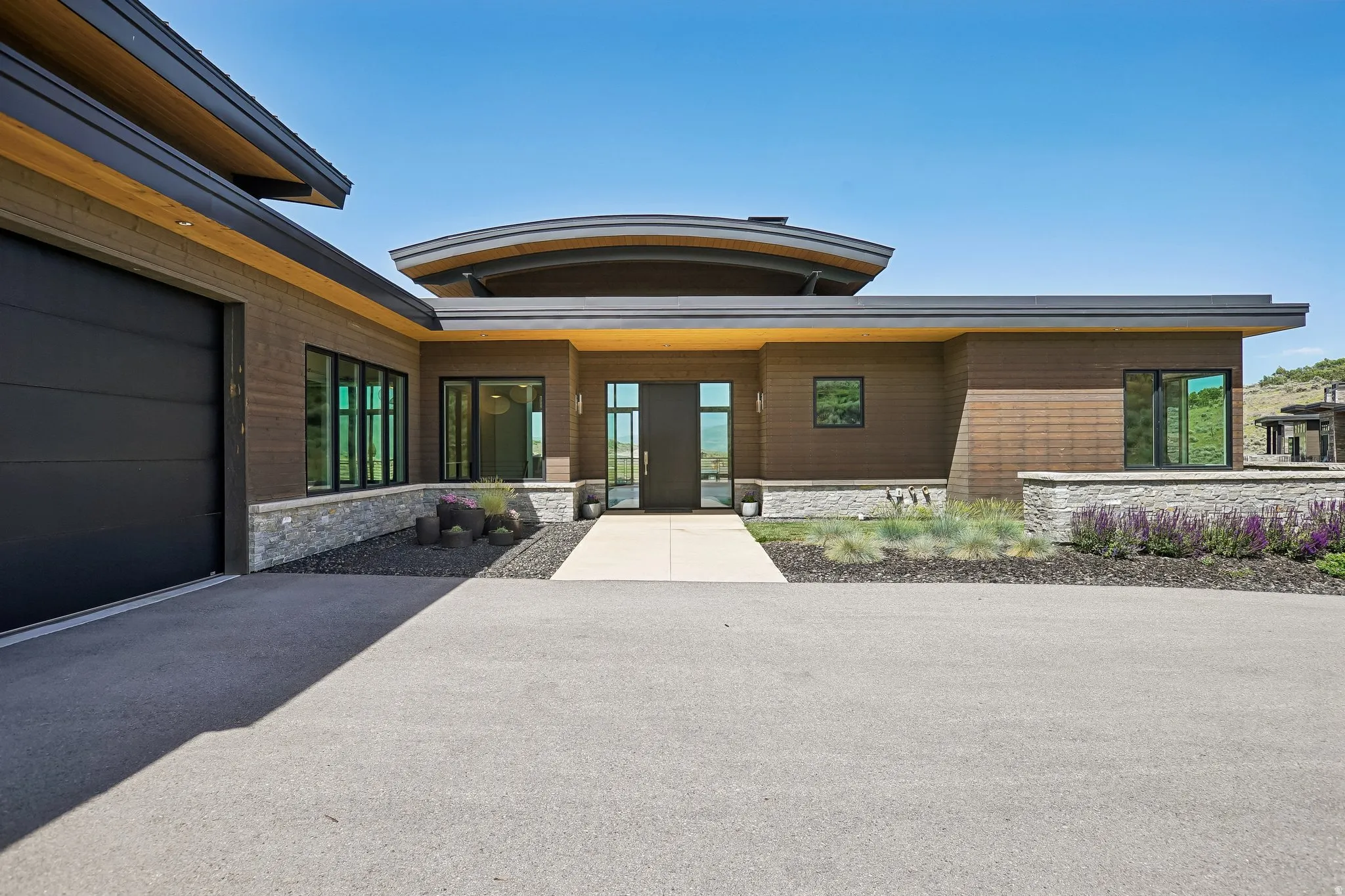 Contemporary architecture featuring wood-finish siding and stone accents