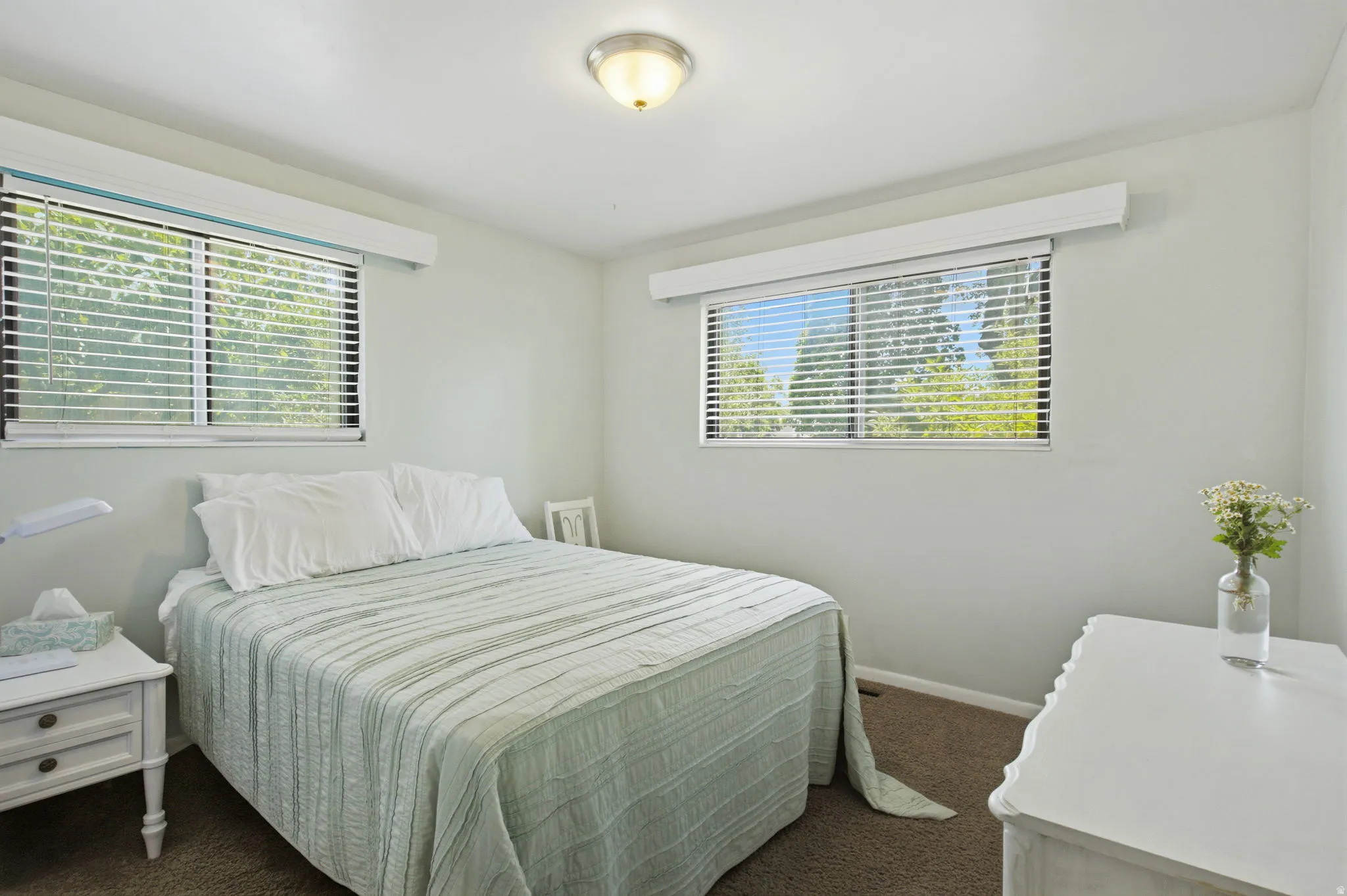 Neutral wall paint with two windows featuring horizontal blinds
