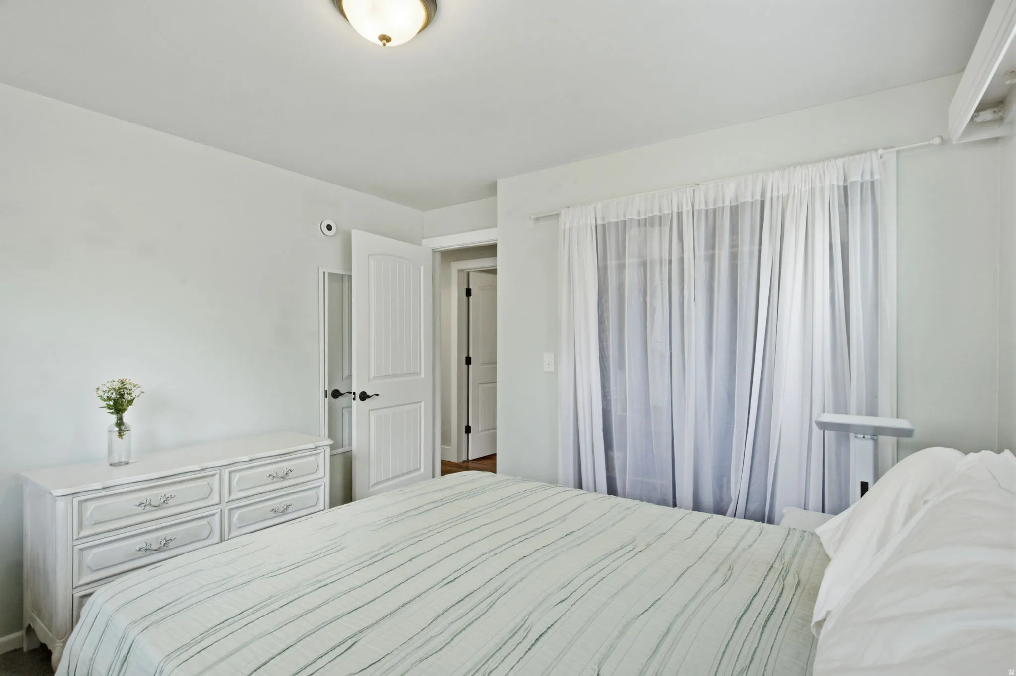 Room featuring light-colored walls and a semi-flush mount ceiling light