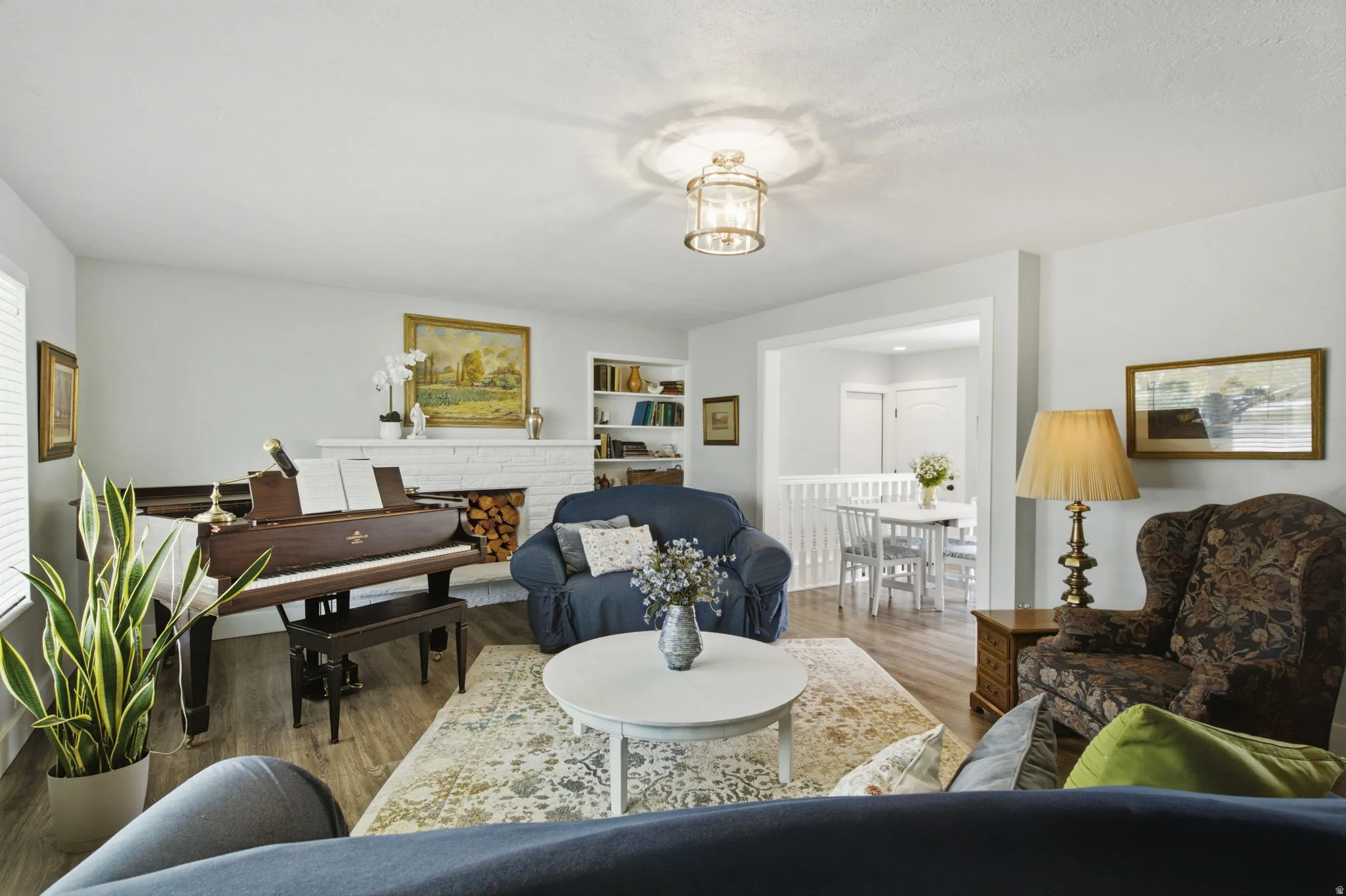 Bright living area featuring wood-finish flooring and white walls