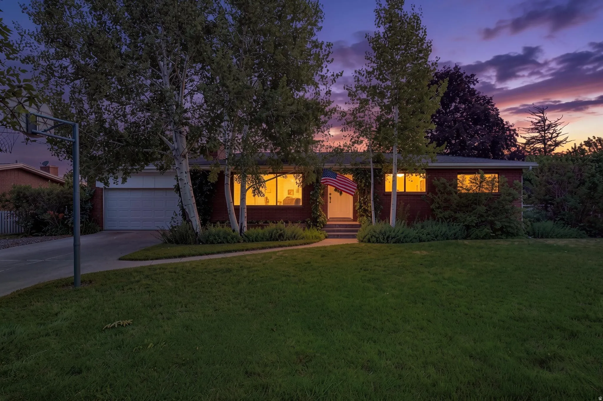 Single-story brick residence with an attached garage and concrete driveway