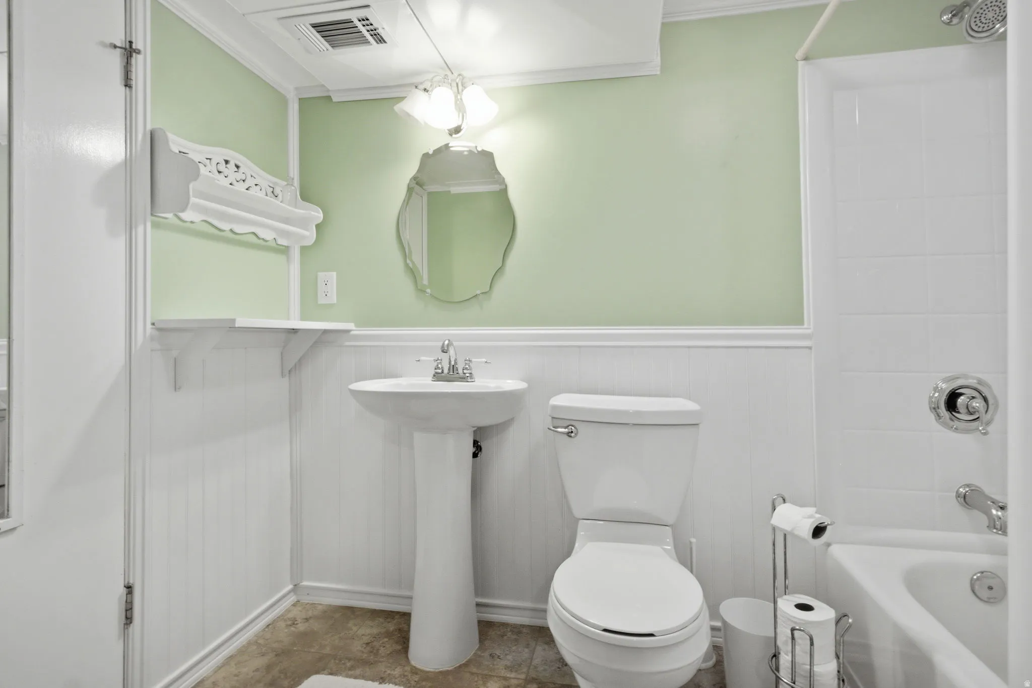 Bathroom featuring a pedestal sink, a toilet, and a combined shower and bathtub