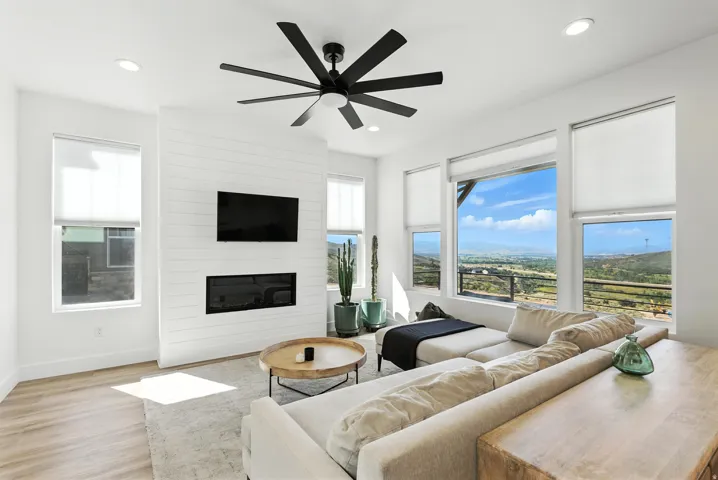Living area featuring wood-finish flooring and multiple windows