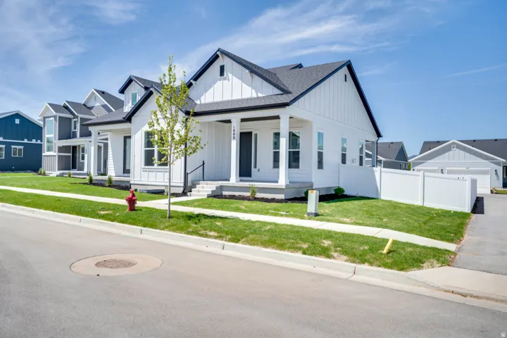 Contemporary residence featuring white board and batten siding with black trim accents