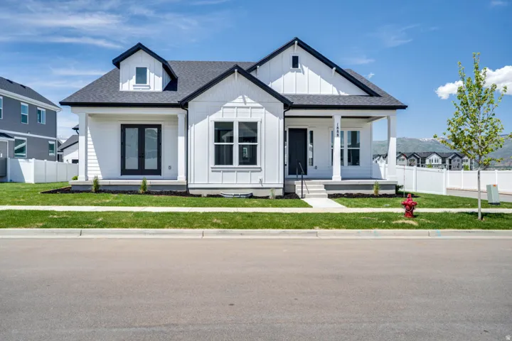 Modern farmhouse architecture featuring white board and batten siding with black trim accents