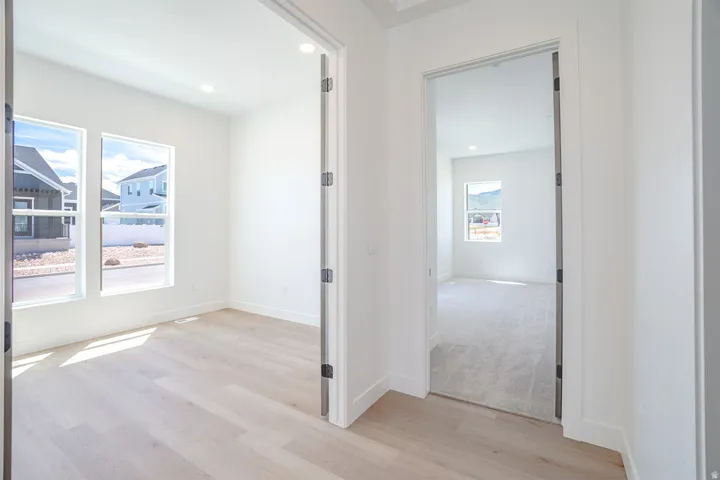 Bright interior space featuring light wood-finish flooring, recessed lighting, and white trim