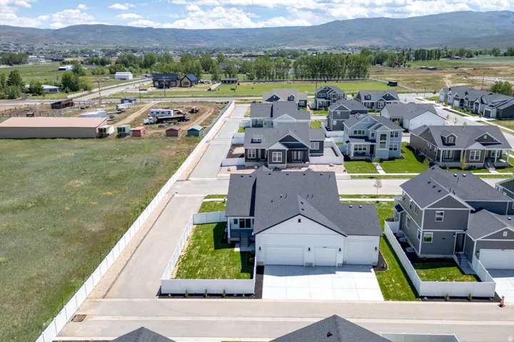 Contemporary residential area with newly constructed homes, each featuring a private yard and attached garage