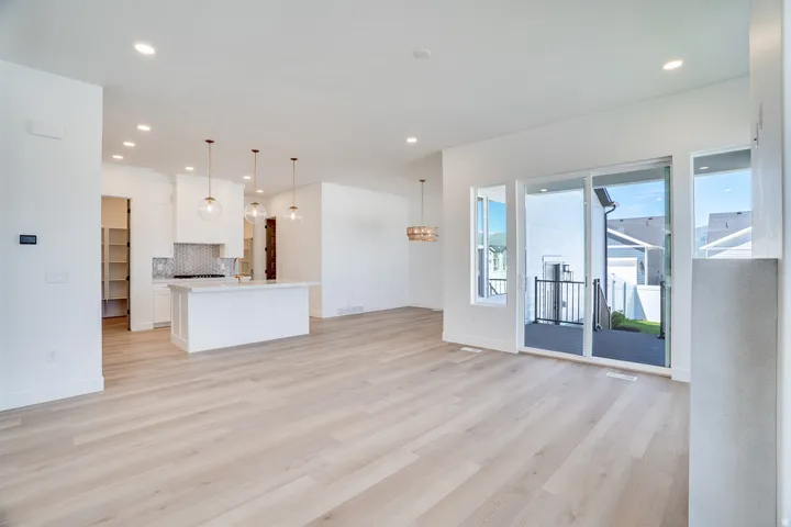 Open-concept living area with light wood-finish flooring