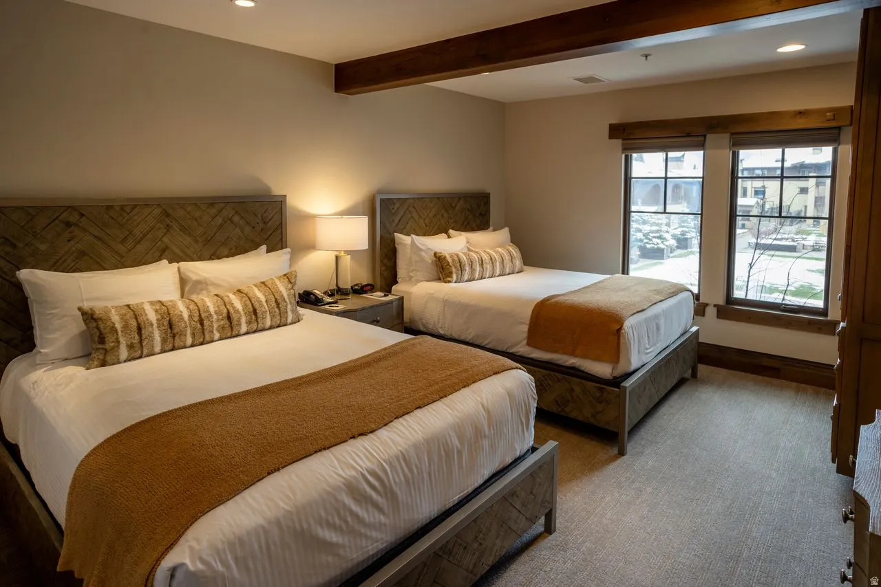 Wood-finish headboards and bed frames define this room