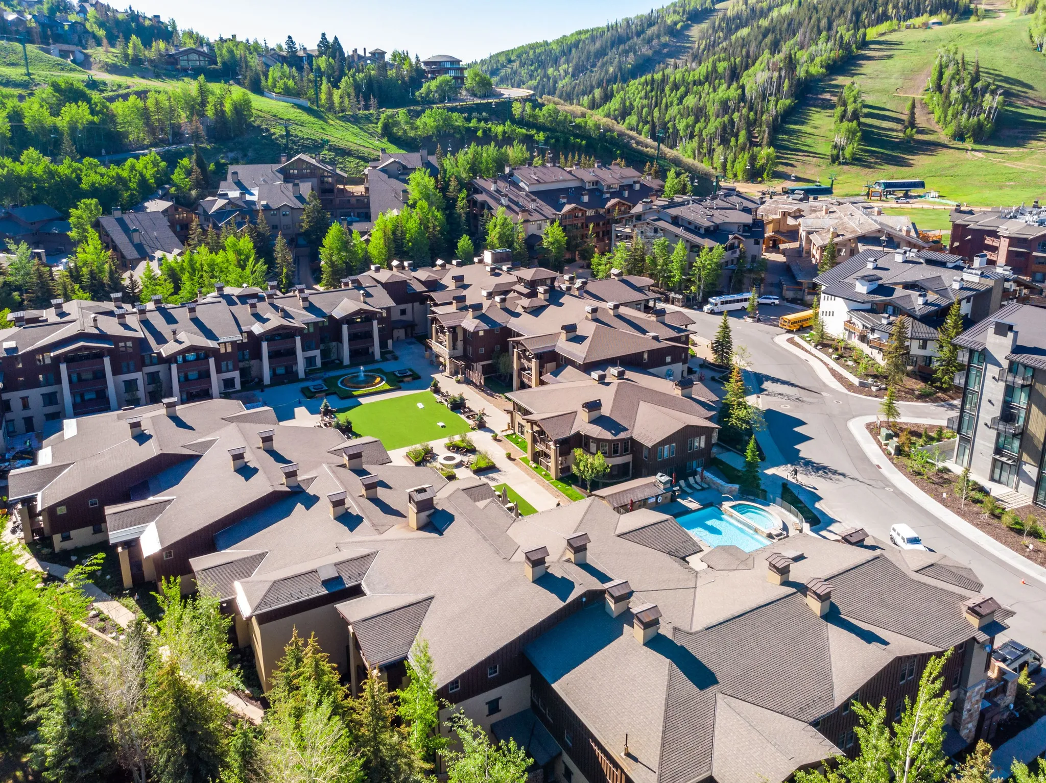 Extensive multi-story residential buildings featuring dark roofing and wood-paneling accents