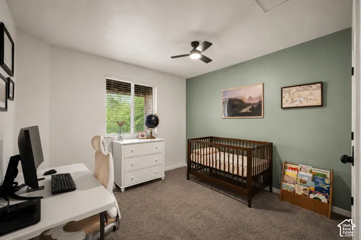 Room featuring neutral carpeting, a window with blinds, and a ceiling fan with integrated lighting