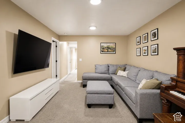 Carpeted room with recessed lighting and neutral wall tones