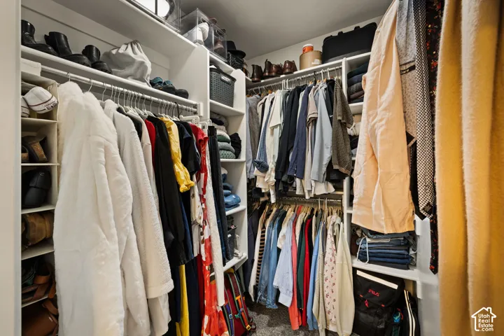 Custom closet system featuring multiple hanging rods, integrated shelving, and dedicated shoe storage