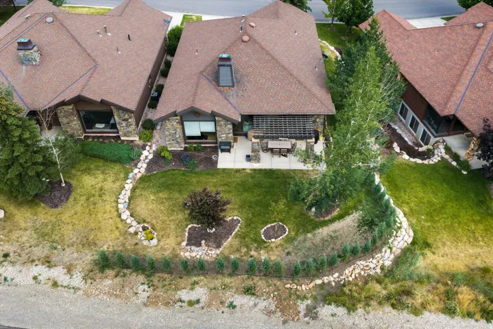 Stone-accented exterior with a brown shingle roof and a skylight