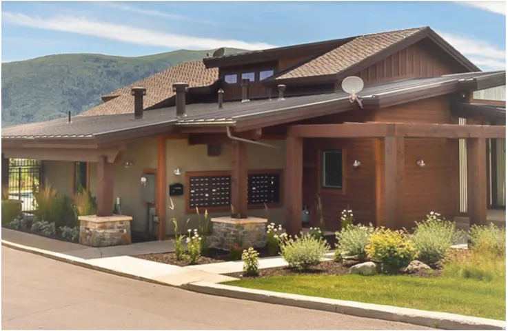 Multi-textured exterior featuring wood siding, stucco, and stone accents