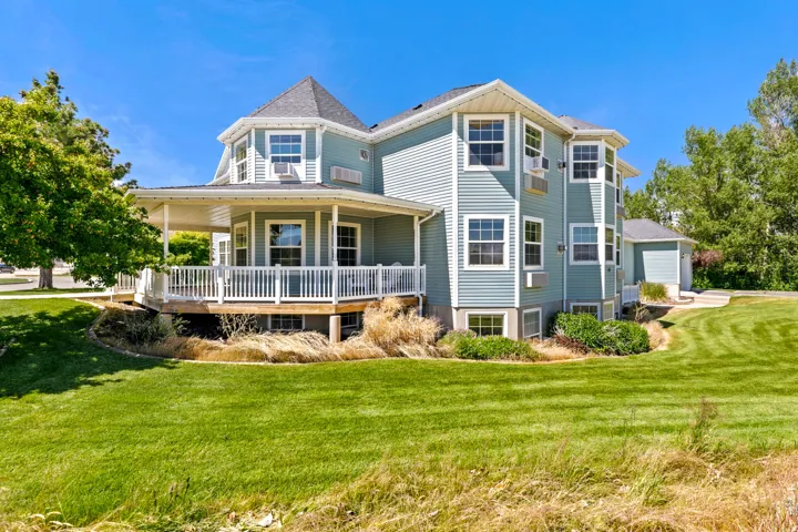 Multi-level property with light blue horizontal siding and white trim