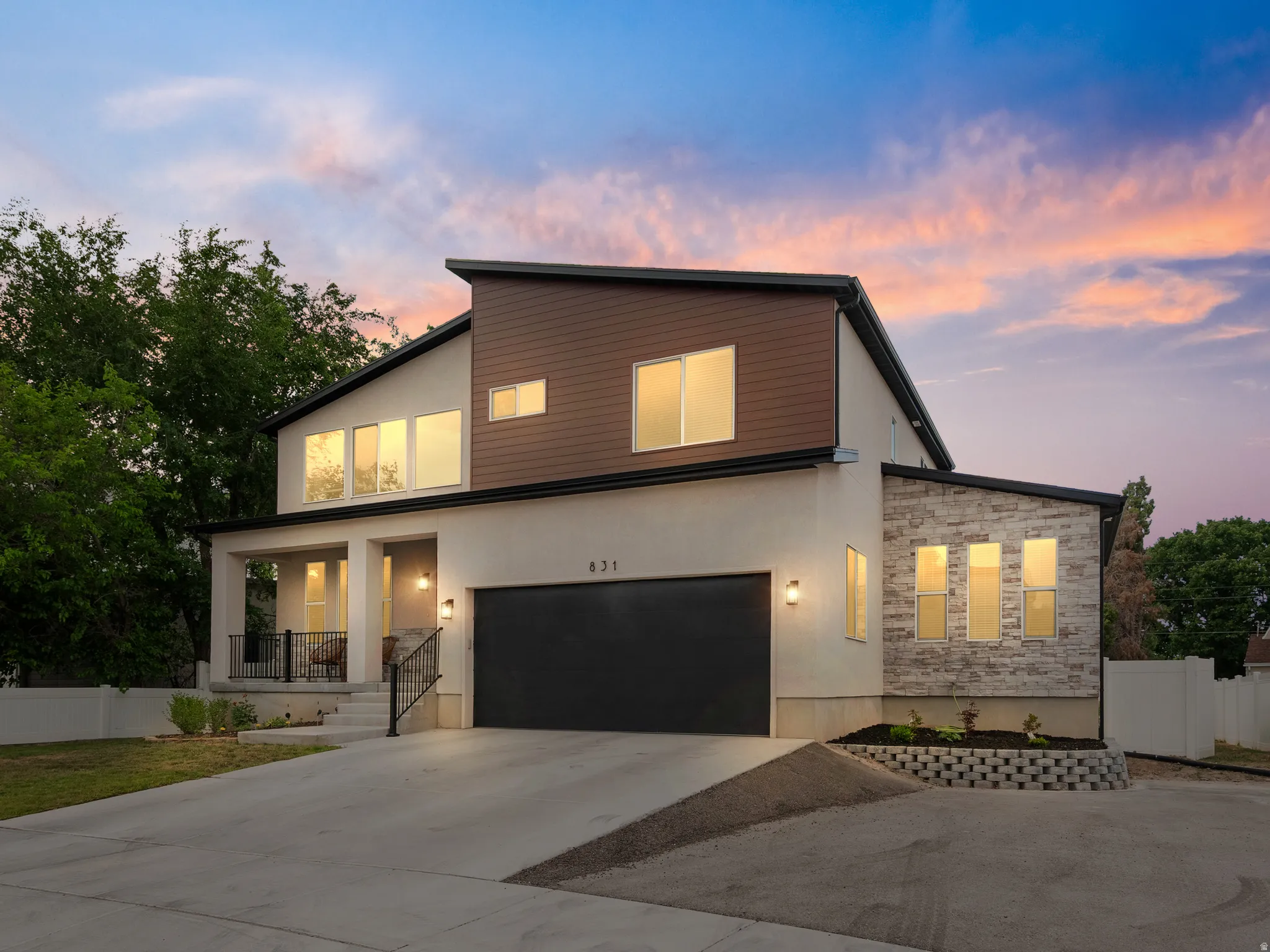 Modern architectural design featuring varied facade materials including stucco, wood-look siding, and stone accents