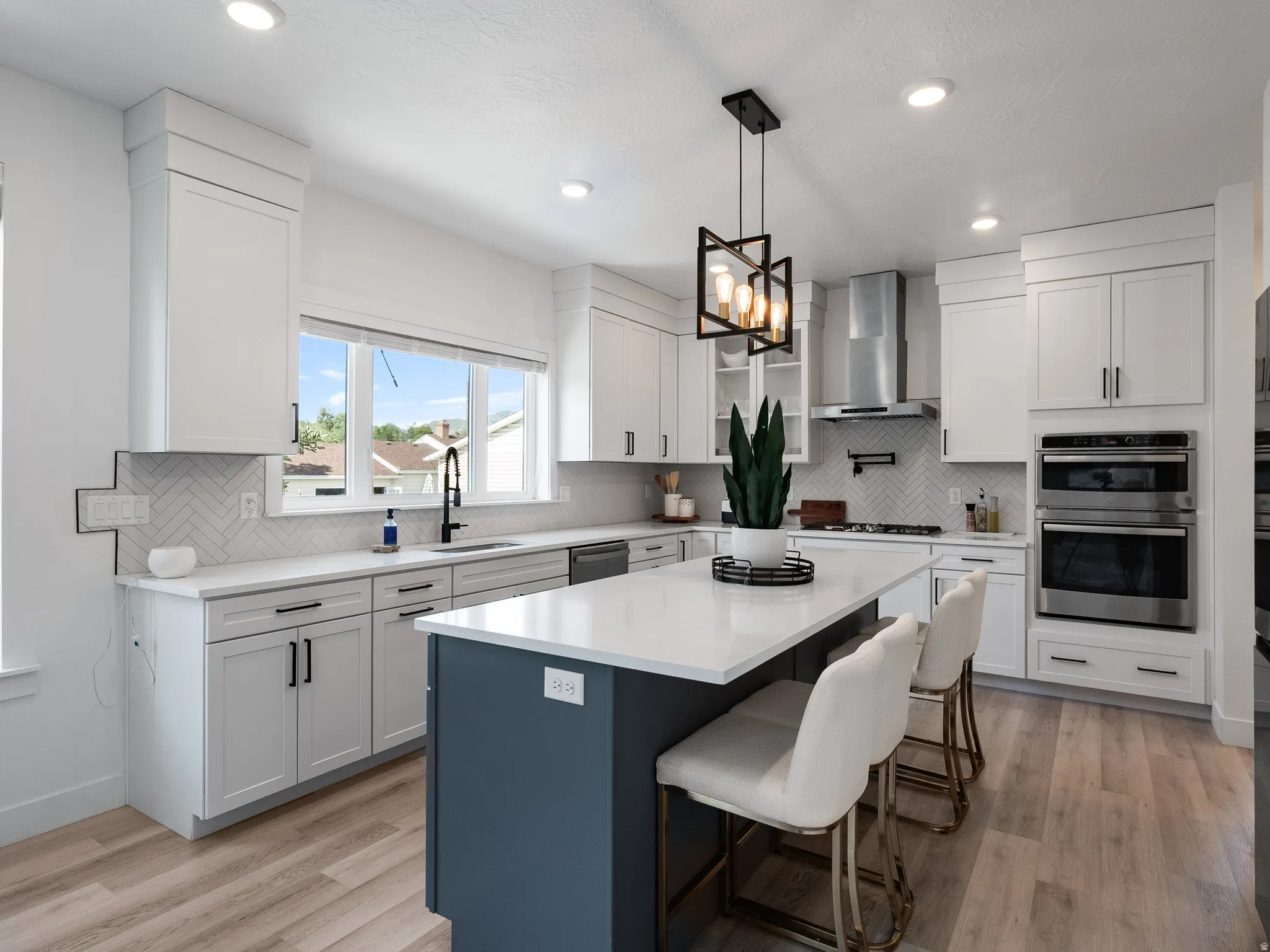 Contemporary kitchen featuring a two-toned island with a white countertop