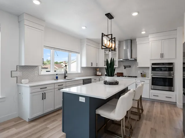 Contemporary kitchen featuring a two-toned island with a white countertop