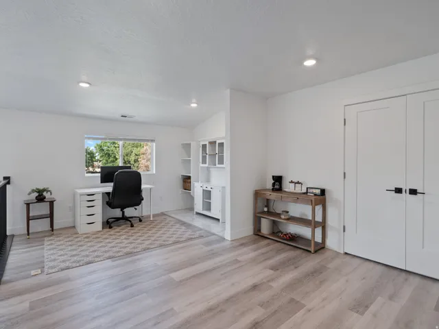 Open-concept space featuring light wood-finish flooring and recessed lighting