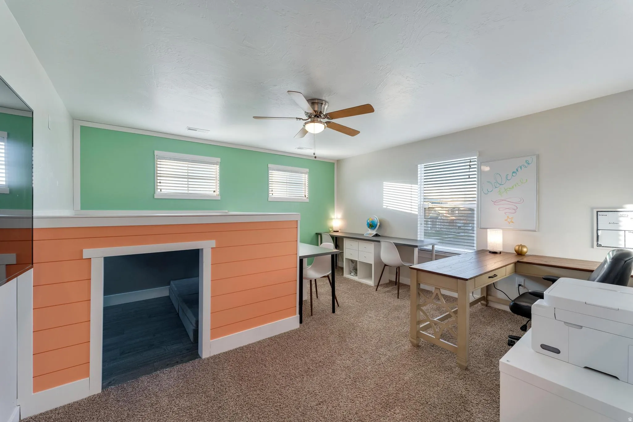 Carpeted room with a ceiling fan and recessed lighting