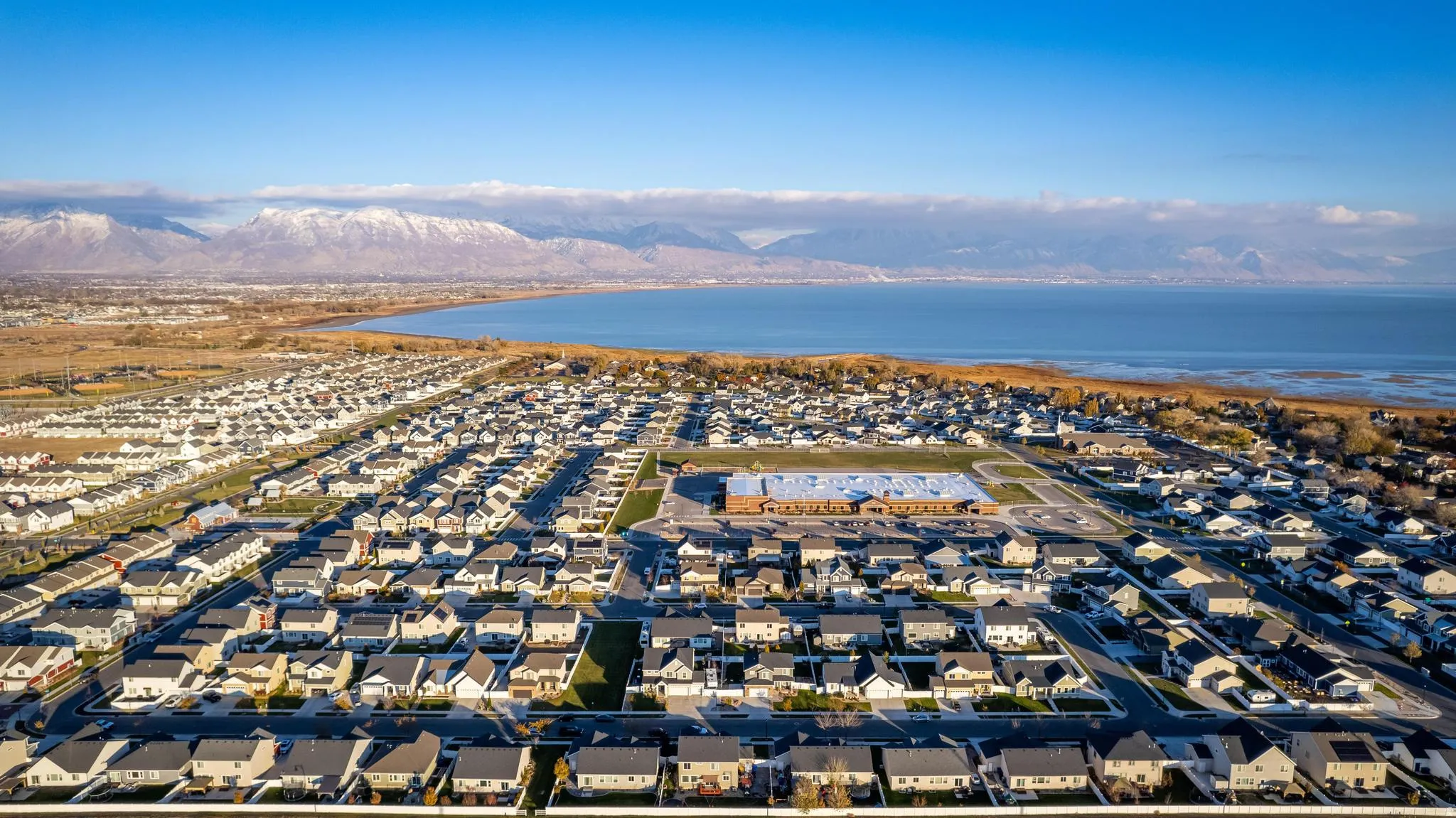 Extensive residential development featuring numerous single-family homes with uniformly dark roofs