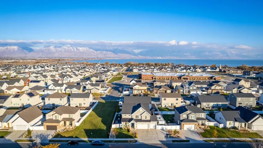 Expansive residential neighborhood featuring numerous single-family homes with diverse architectural styles, visible streets, and green spaces
